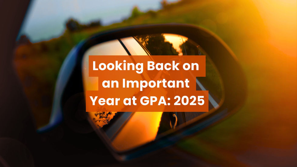 A car’s side mirror reflecting a road at sunset, overlaid with the text “Looking Back on an Important Year at GPA: 2025” in bold orange and white lettering.