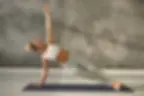 A woman doing the side plank movement in Pilates