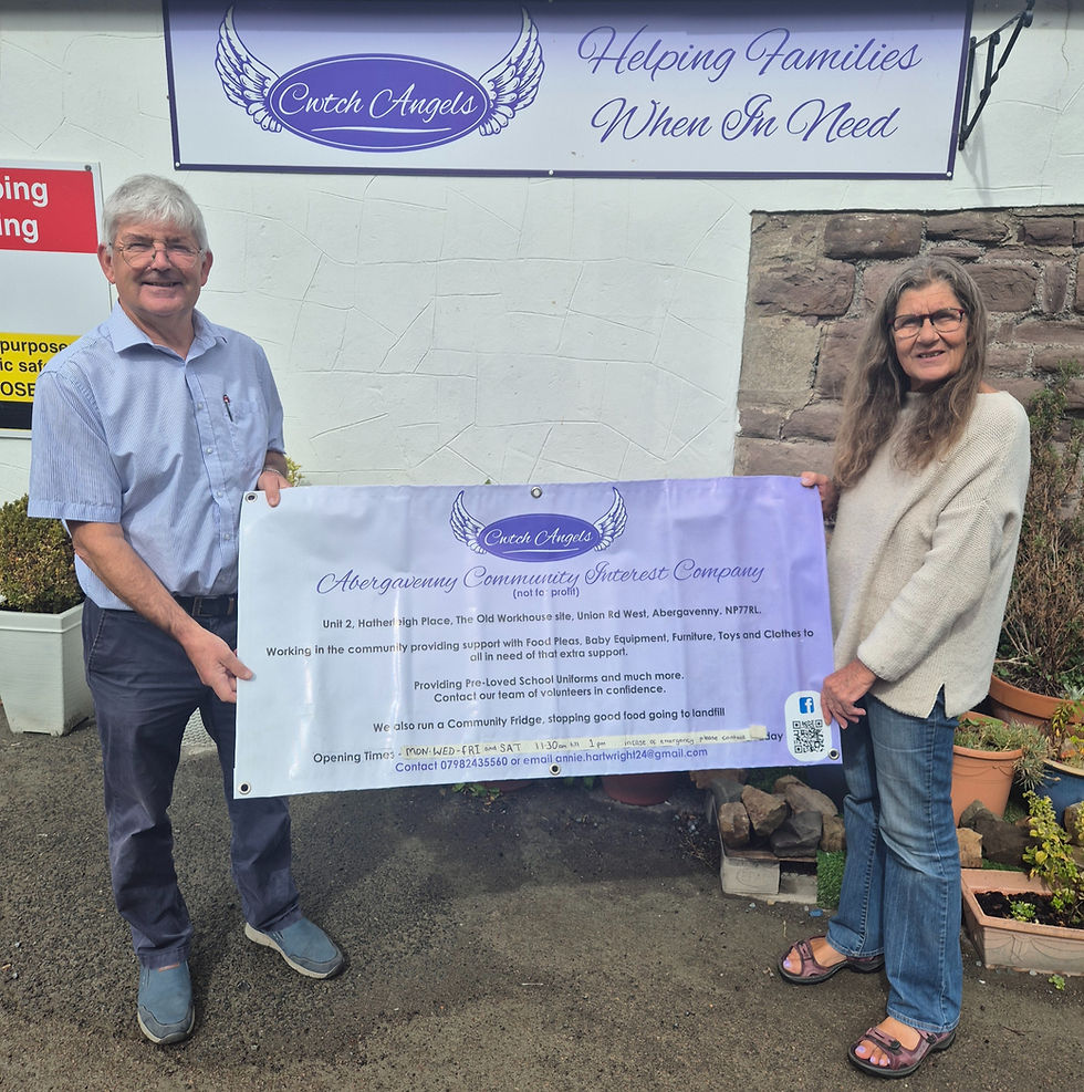 Rotary president keith Spencer presenting a cheque to annie hartwright
