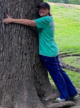 Picture of author hugging a tree