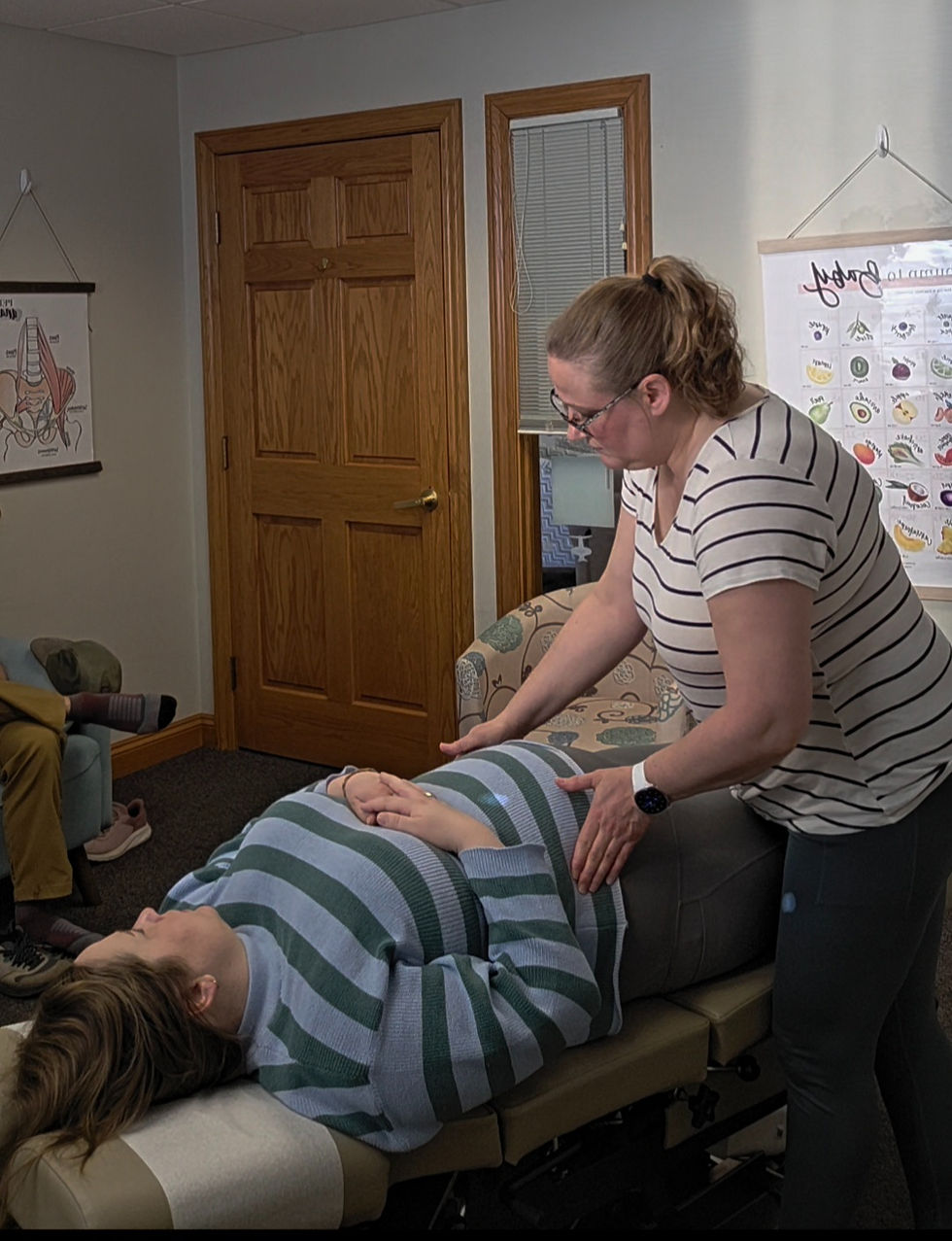 A chiropractor adjusting a woman