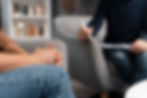 Person with hands together talking to a coach