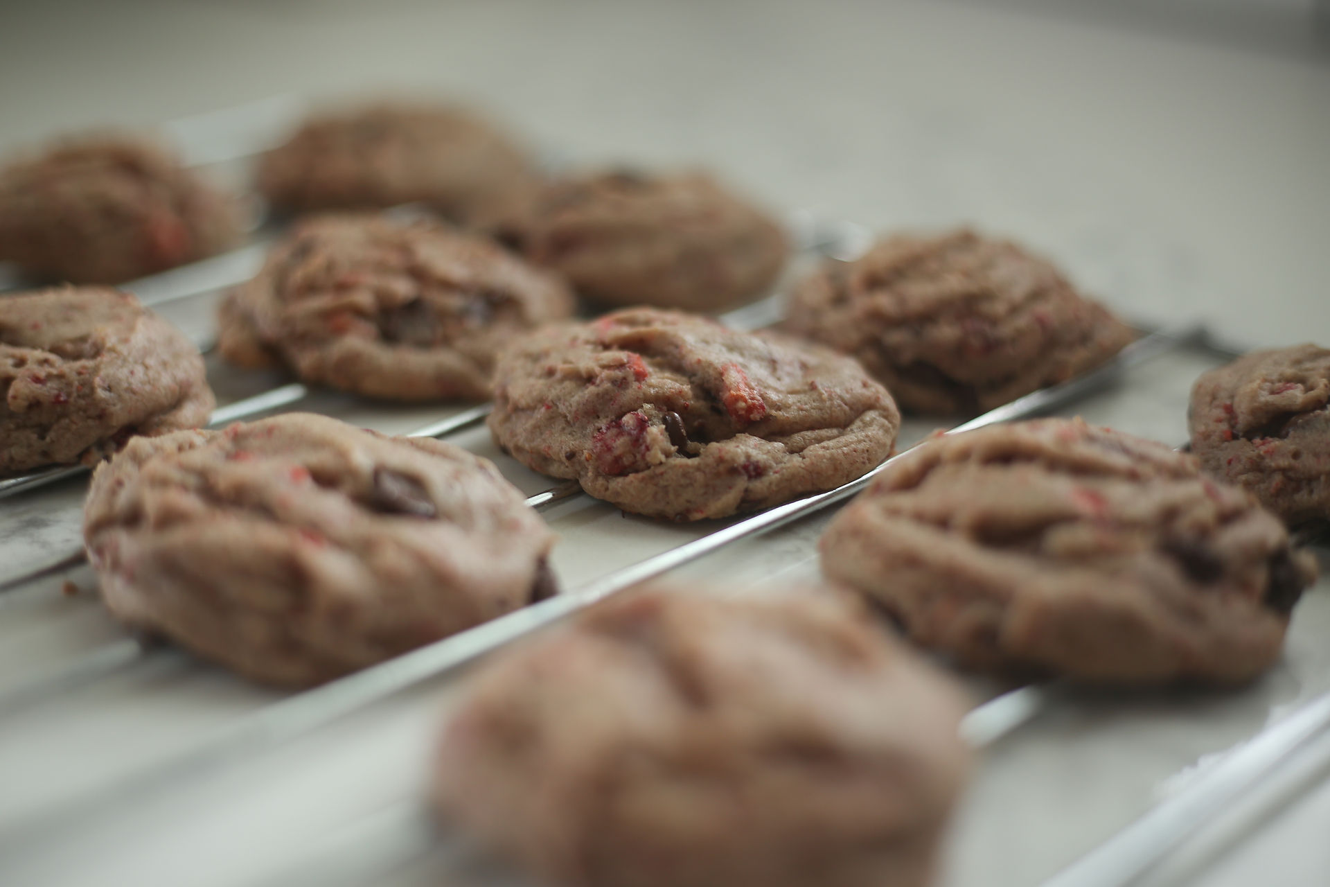 chocolate covered strawberry cookies cooling on rack