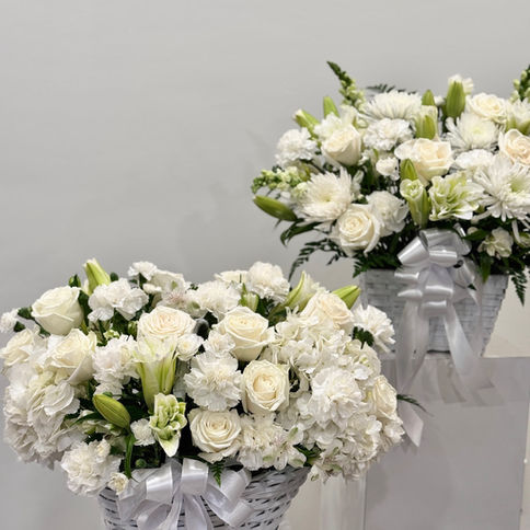 A calm and elegant white floral arrangement, created for moments when words fall short.