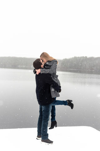 proposal in snow on lake.