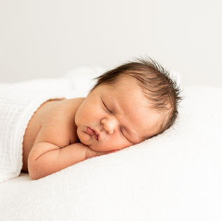 Sleeping naturally positioned newborn baby photographed in natural light at Caz Wales Photography studio in Thame, Oxfordshire.