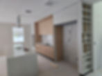 Luxury custom made kitchen under construction with wood and white cabinetry.