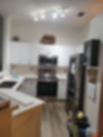 Modern kitchen with white cabinets, stainless steel appliances