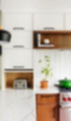 Luxury custom made kitchen with white cabinets and wood accents.