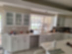 Luxury custom made kitchen with white cabinets and large window