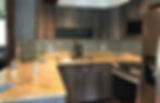 Luxury custom made kitchen with dark cabinets and granite counters