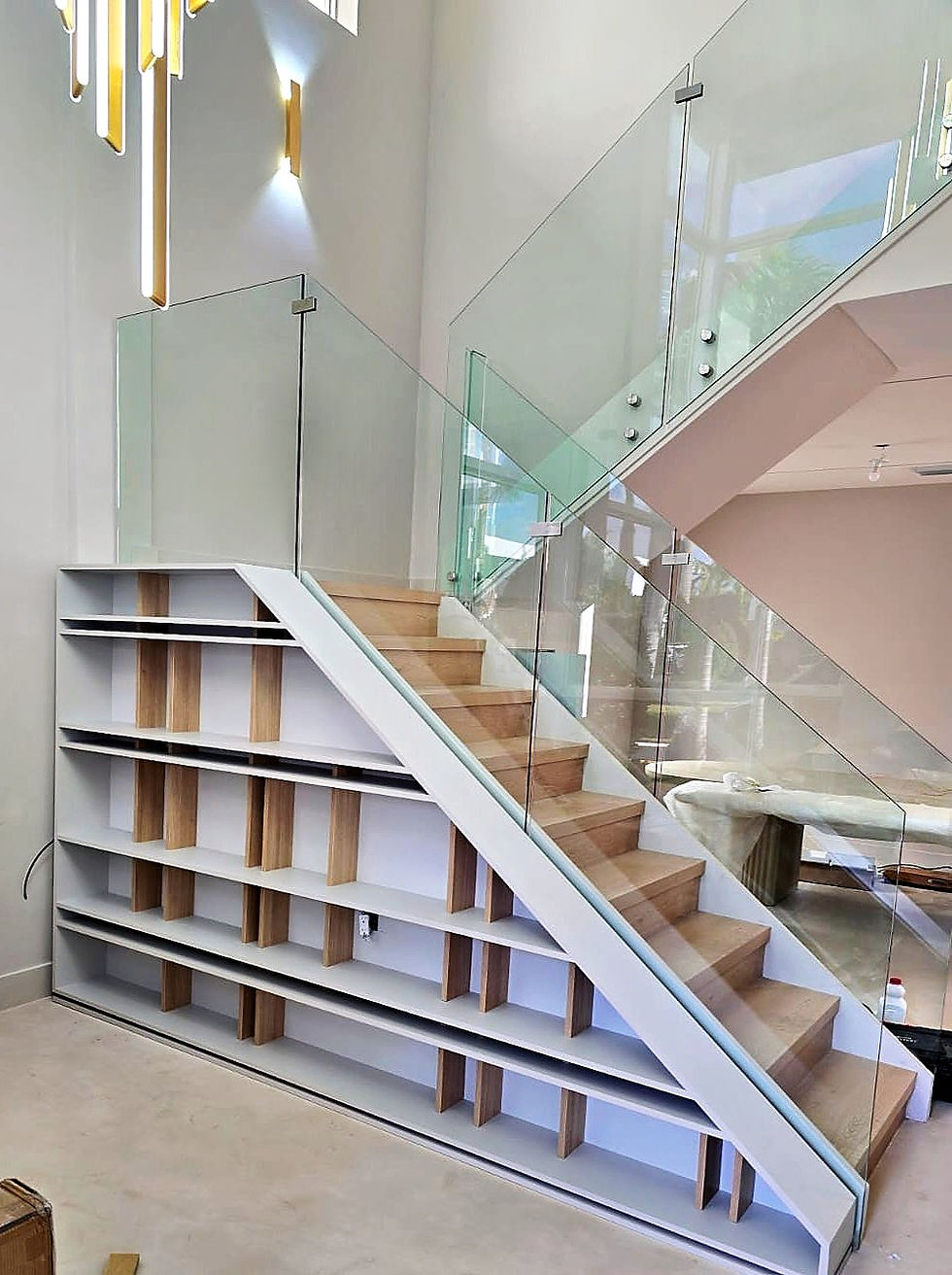 Custom built-ins Miami under-stair white shelving unit
