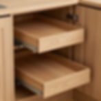 Two pull-out wooden drawers in a custom made kitchen cabinet