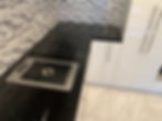 Black countertop, sink, and stovetop in luxury custom made kitchen