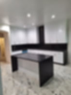 Luxury custom kitchen: white cabinets, black counters, island