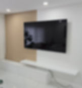 Modern living room with a TV and wooden slat feature wall
