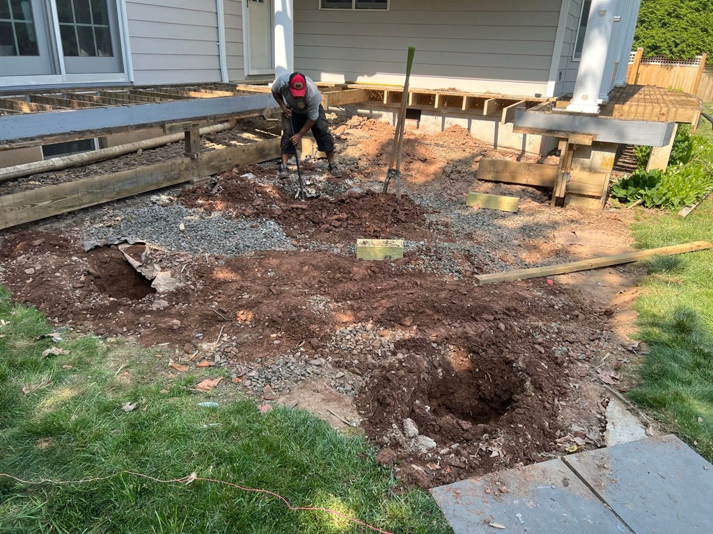 Person in yard digging holes.