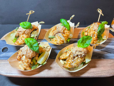 chicken satay, peanut sauce on a cucumbe