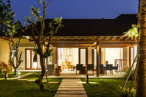 Minimalist luxury villa living room featuring custom millwork and seamless indoor-outdoor architectural flow.