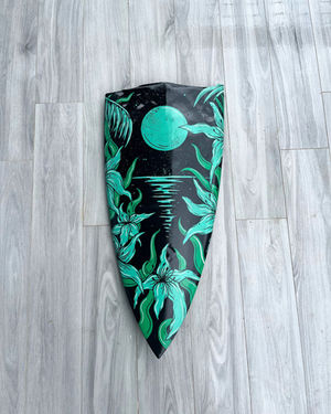 Moonlight on water painted on a half surfboard, in turquoise and black.