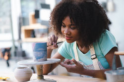happy smiling girl having fun to learning and work with craft art of clay hand-made worksh