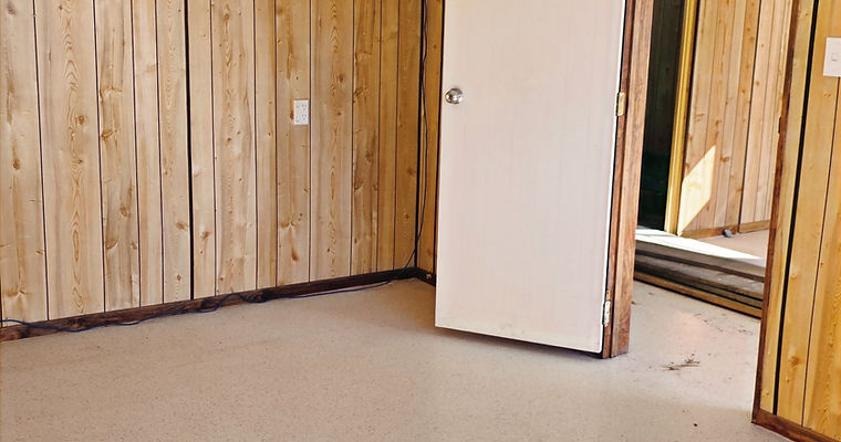 Empty room with wood paneled walls for sale