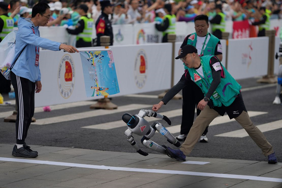 A robot loses control at the start of what is billed as the world's first robot half marathon in Beijing, Chaina, on April 19, 2025. - Ng Han Guan/AP
