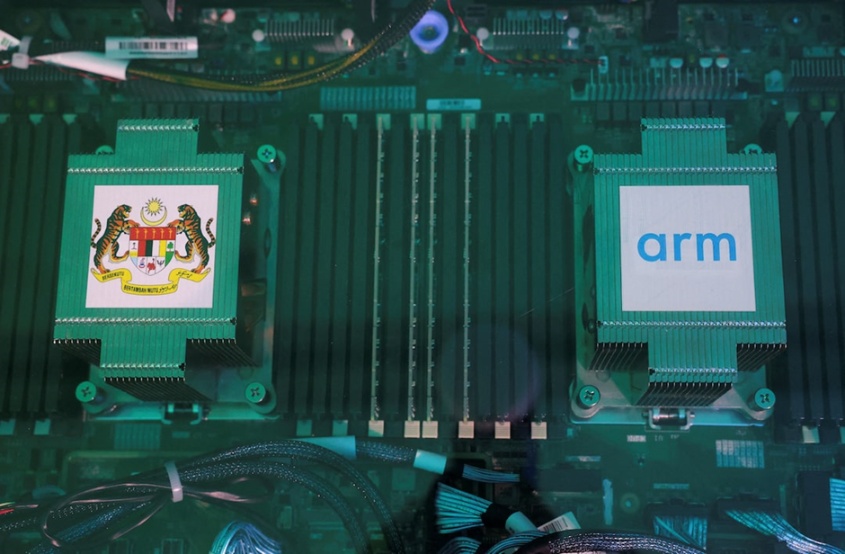 The Malaysian government emblem and Arm Holdings' logo are seen on the chips during an event in which Malaysia's Prime Minister Anwar Ibrahim announces a $250 million deal with Arm Holdings, in Kuala Lumpur, Malaysia, March 5, 2025. REUTERS/Hasnoor Hussain