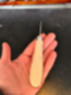 An awl. Used for stretching leather back to its place.