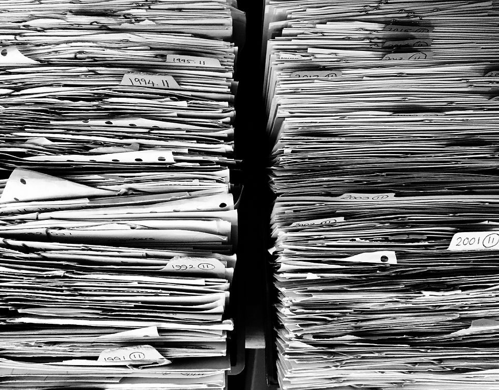 Two large stacks of papers with year tabs sticking out
