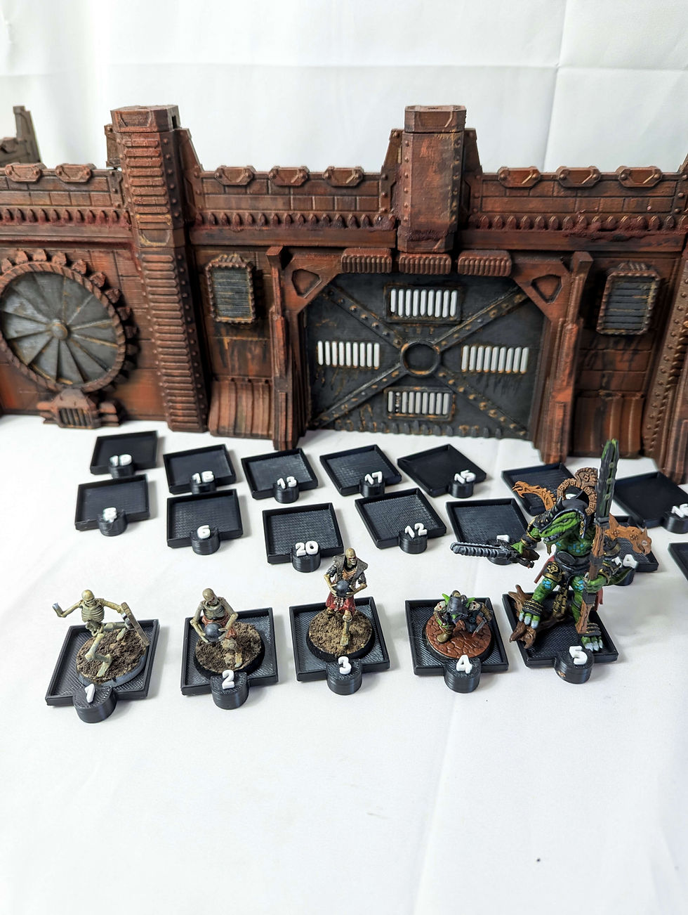 Thumbnail: Miniature holders with number markers for use in tabletop games