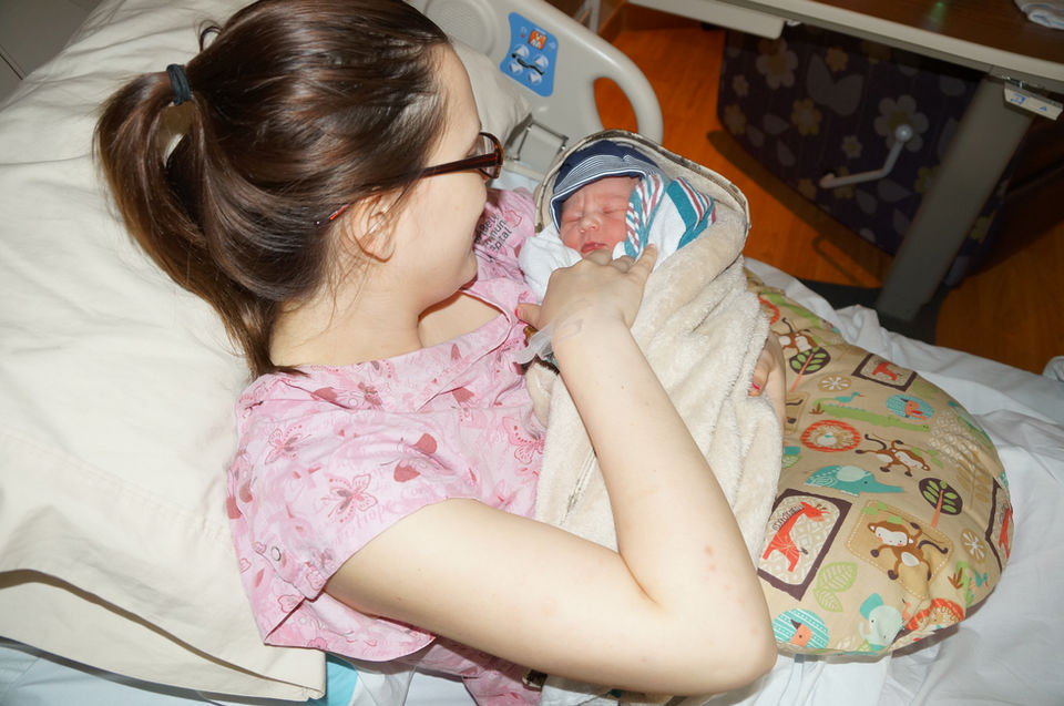 Smiling mother and newborn in the hospital