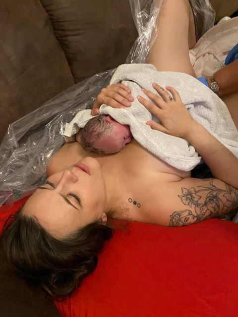 Newborn resting on mothers chest.