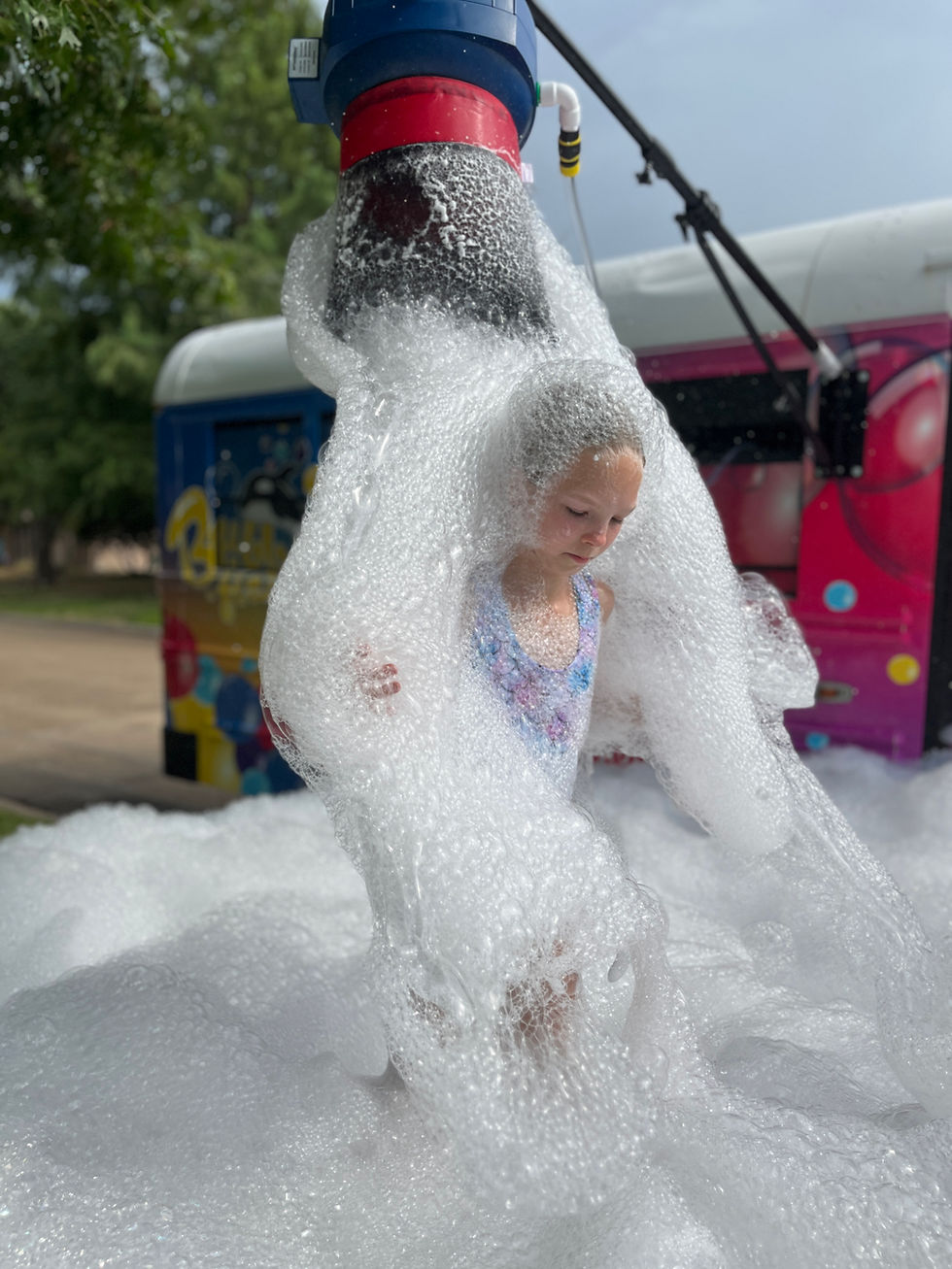 Little girl covered in bubble foam