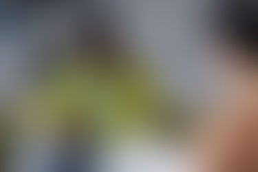 Smiling client engaged in conversation with a therapist during a session, representing collaboration and emotional safety.