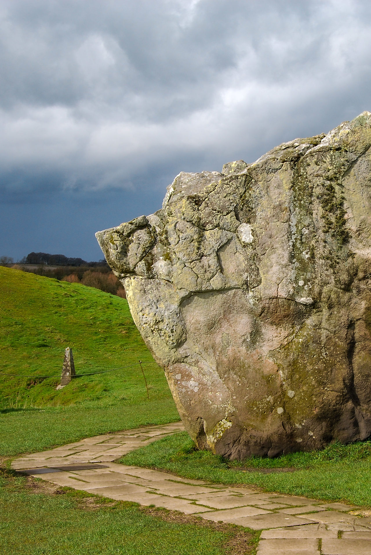 A huge standing stone with a path curving around it