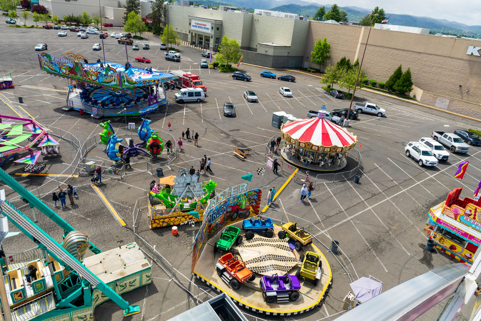 an aerial view of a carnival in a parking lot By Eternal Exposure Medford, Oregon