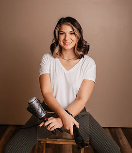 Ashley R holding a round brush and dryer.