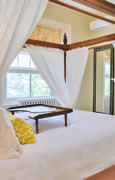 Luxurious Sopwell Suite master bedroom with a grand canopy bed, cozy fireplace, and timeless elegance.