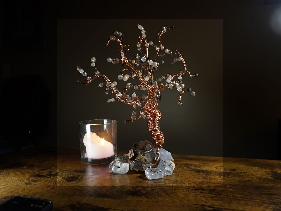 Signature Ever Tree art piece with crystals wire and a candle on a wood table