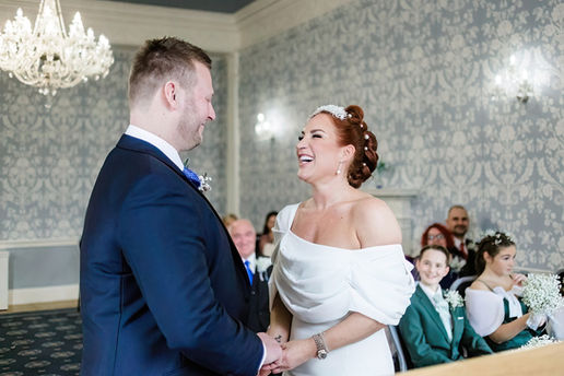 Bride and groom laughing during wedding ceremony at Langtons House