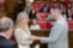 Bride giving groom ring during wedding in the Grand Chamber in Wandsworth Town Hall