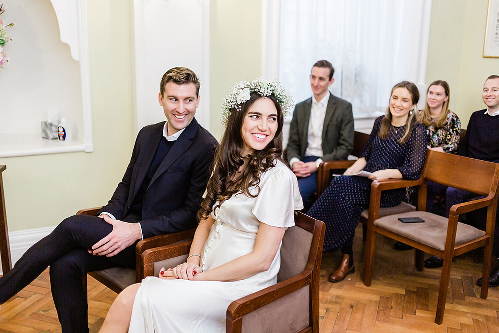 Bride and groom during wedding ceremony in the Rosetti Room at Chelsea Old Town Hall