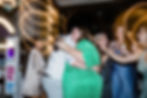 Groom hugging wedding guest at west London pub reception