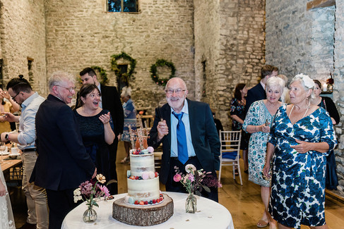 Guest posing with wedding cake in Bath, Somerset