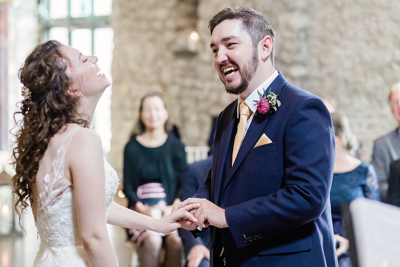 Couple exchanging wedding rings at Priston Mill