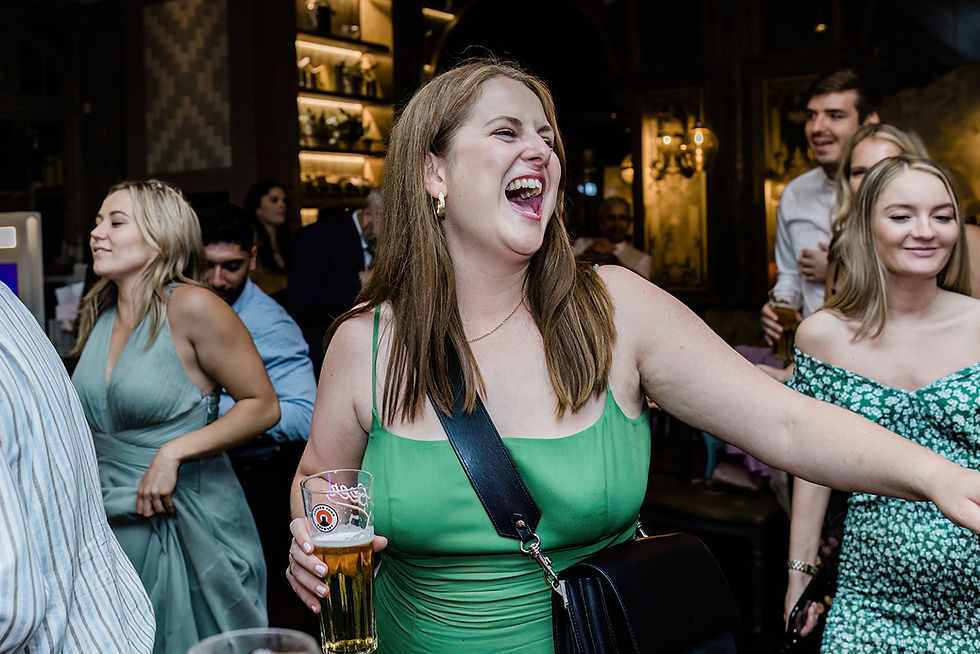 Laughing guest dancing at Duke's Head Putney wedding