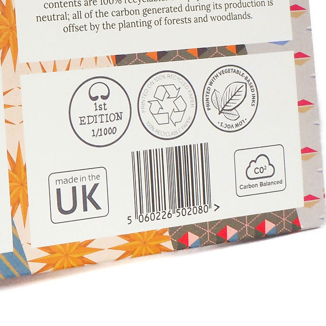 close up of sustainable logos on the back of bright stems vintage style recyclable wrapping paper