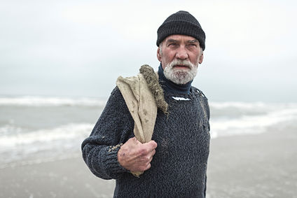 Senior-beachcomber-with-burlap-sack-and-
