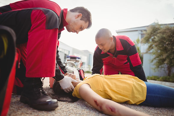 paramedics-examining-injured-woman.jpg